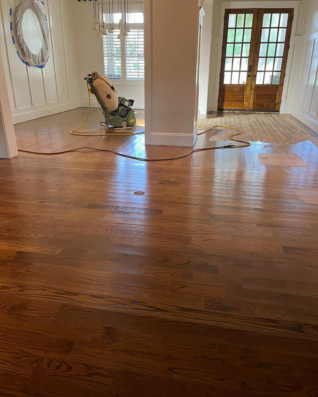 Person sanding hardwood floors
